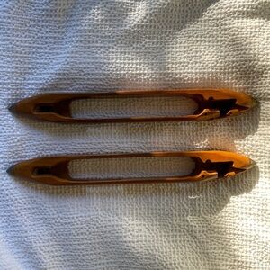 Two wooden weaving boat shuttles. Bobbins. Lowell Shuttle Co. Mass. #1562.